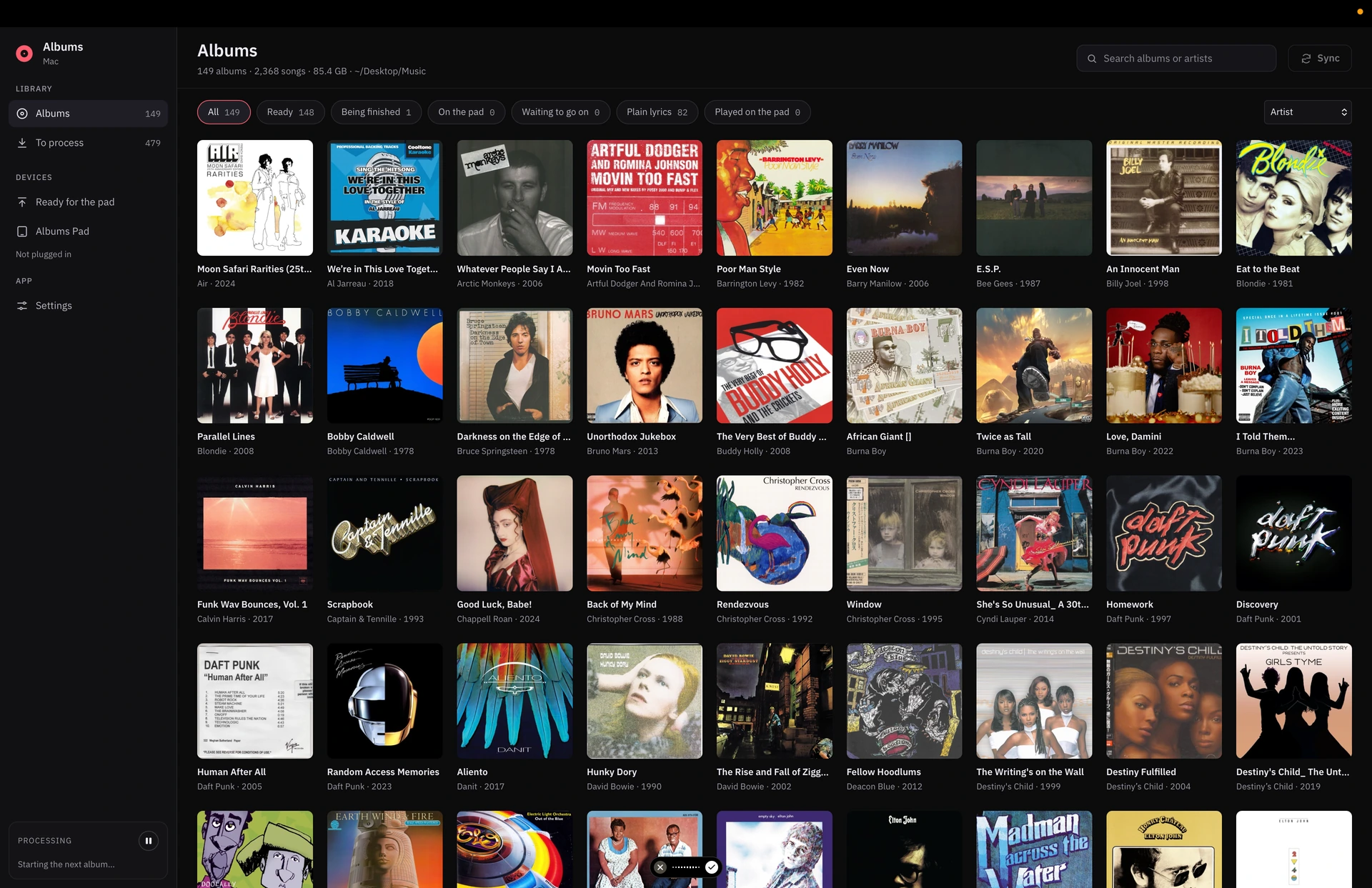 Albums interface showing a music library organised as a grid of album covers, with library and device controls in the sidebar