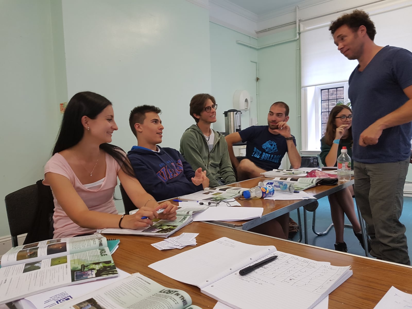 James Casey leading a group discussion around a table with learning materials